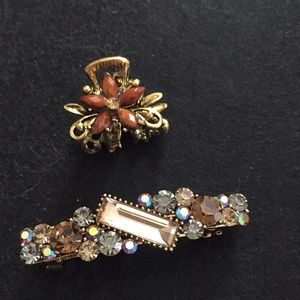 2 hair clips one has gems claw clip has flower